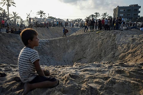 Palestinians look at the destruction following an Israeli airstrike on a crowded tent camp for those displaced by the ongoing conflict in Muwasi, Gaza Strip, on September 10, 2024.