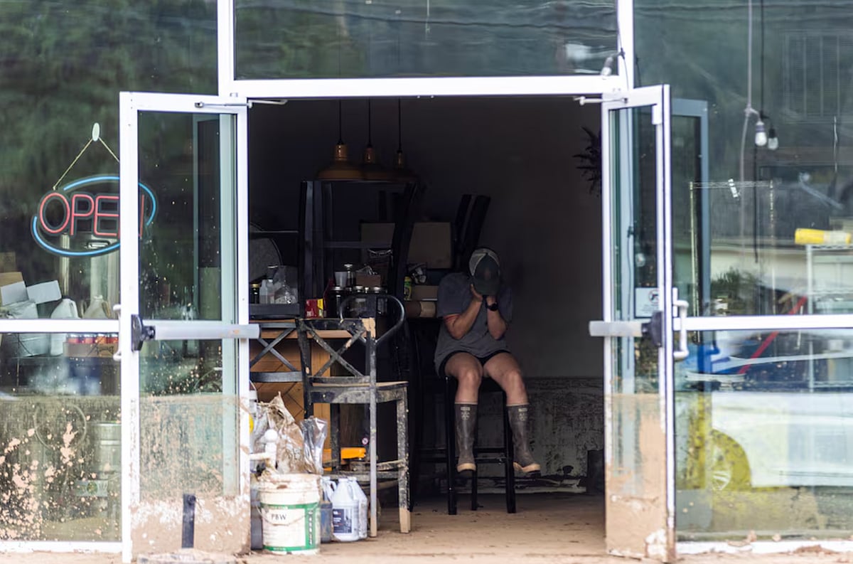 Reuters  : A woman reacts inside a store affected by floods following the passing of Hurricane Helene,
