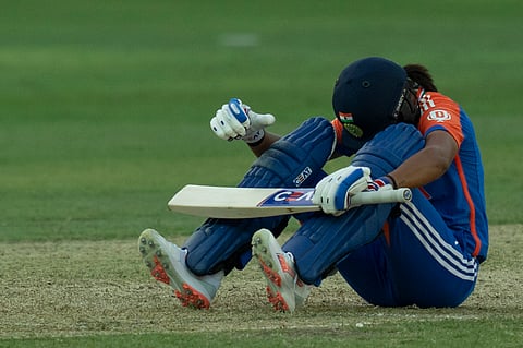 India's captain Harmanpreet Kaur sits on the pitch as she hurt herself while batting during the ICC Women's T20 World Cup 2024 match between Pakistan and India at Dubai International Stadium, United Arab Emirates, Sunday, Oct. 6, 2024.
