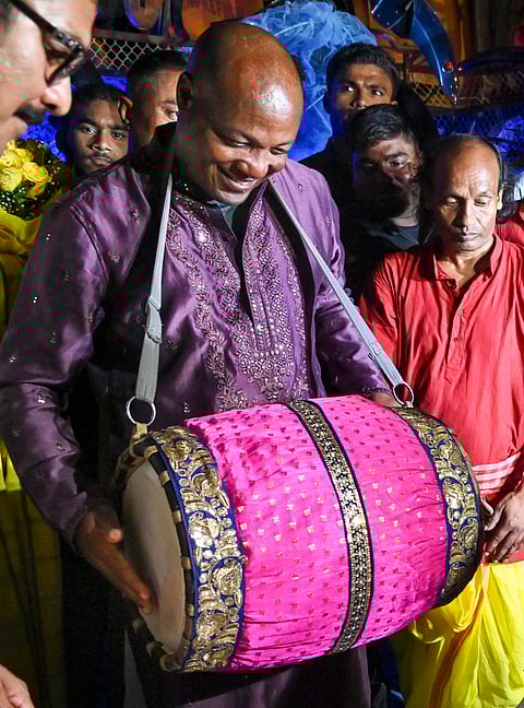 Kolkata: Former West Indies cricketer Brian Lara plays an instrument during his visit to a community puja pandal amid the Durga Puja festivities at Suruchi Sangha, in Kolkata, Sunday, Oct. 6, 2024.