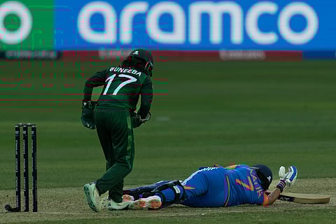 India's captain Harmanpreet Kaur falls on the pitch as she loses her balance as she hurt herself while trying to make it back to the crease at full stretch during the ICC Women's T20 World Cup 2024 match between Pakistan and India at Dubai International Stadium, United Arab Emirates, Sunday, Oct. 6, 2024.