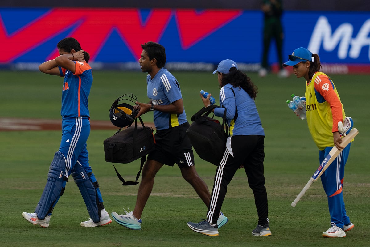 India's captain Harmanpreet Kaur, left, walks back after she hurt herself while batting during the ICC Women's T20 World Cup 2024 match between Pakistan and India at Dubai International Stadium, United Arab Emirates, Sunday, Oct. 6, 2024.  - (AP Photo/Altaf Qadri)
