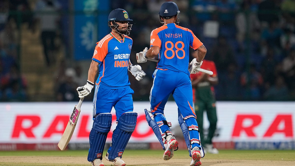 India's Rinku Singh, left, and teammate Nitish Kumar Reddy run between the wickets during the second T20 cricket match between Bangladesh and India in New Delhi - Manish Swarup/AP