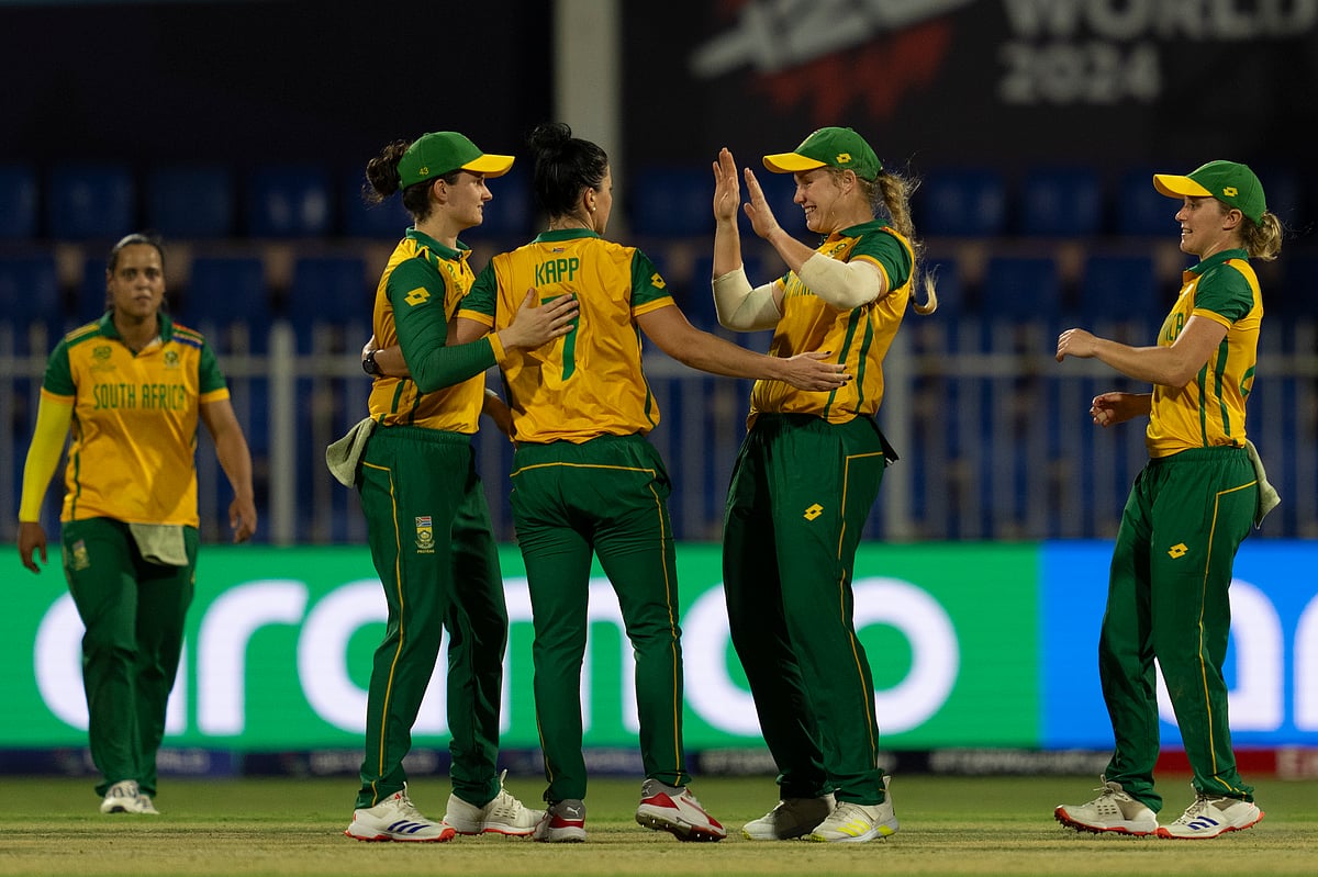 (AP Photo/Altaf Qadri) : South African players celebrate the wicket of England's Maia Bouchier during the ICC Women's T20 World Cup 2024 match between England and South Africa at Sharjah Stadium, United Arab Emirates, Monday, Oct. 7, 2024. 