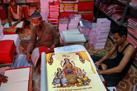 Workers make account books ahead of Diwali