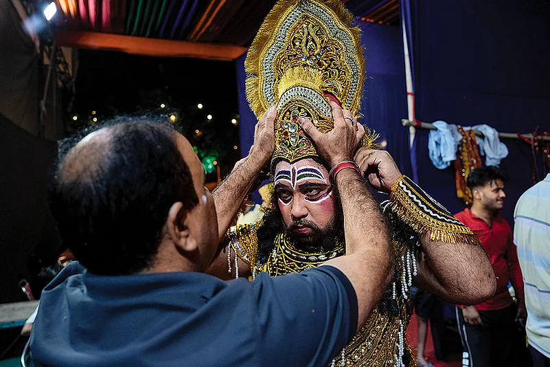 Pankaj Handa is helped by colleagues to wear the Raavan costume