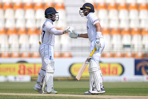 Pakistan vs England: England's Ben Duckett, left, and Joe Root bumps their fists