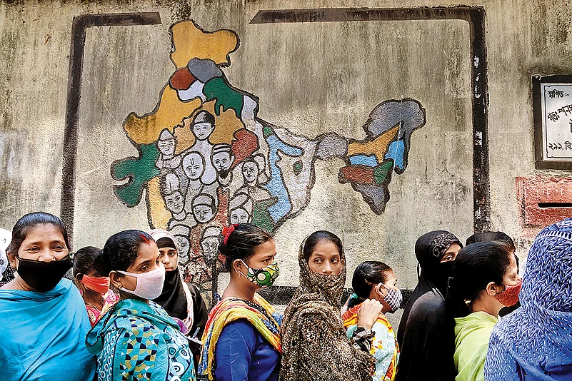 Voters stand in line at a polling station in Kolkata