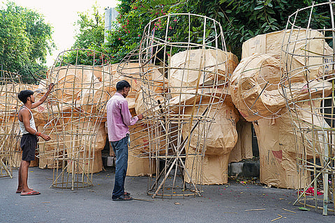 Artisans assemble bamboo sticks before creating an effigy of Raavan