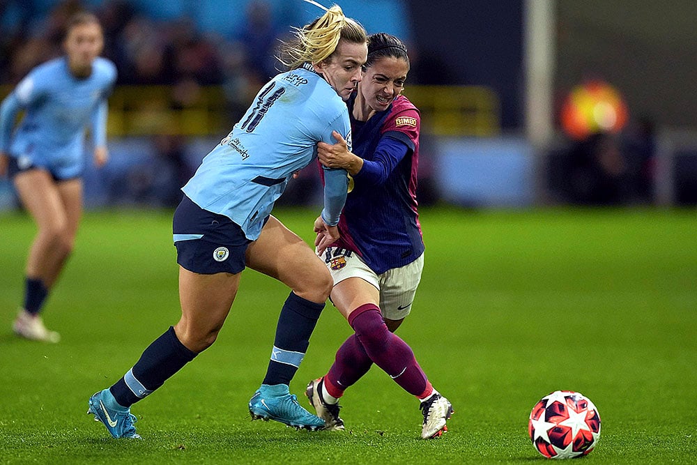 | Photo: Martin Rickett/PA via AP : Women's Champions League: Manchester City's Lauren Hemp, left, and Barcelona's Aitana Bonmati, right, challenge for the ball 