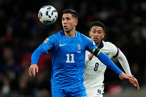 Nations League Soccer: Greece's Tasos Bakasetas, left, and England's Jude Bellingham challenge for the ball