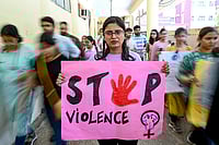 NARINDER NANU/AFP via Getty Images : A medical professional holds a placard during a demonstration to condemn the rape and murder of a medic from Kolkata, at a hospital in Amritsar on August 22, 2024. Saving lives was the childhood dream for 28-year-old Indian doctor Radhika, but after the brutal rape and murder of a colleague her own safety has increasingly become a top concern.