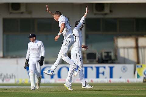 Pakistan vs England: England's Brydon Carse, center, celebrates with teammate after taking the wicket of Pakistan's Mohammad Rizwan