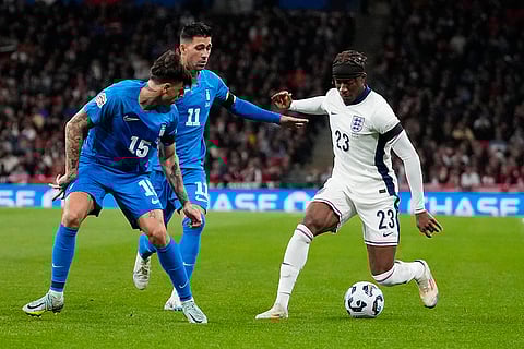 Nations League Soccer: Greece's Lazaros Rota and Tasos Bakasetas, challenge for the ball with England's Noni Madueke