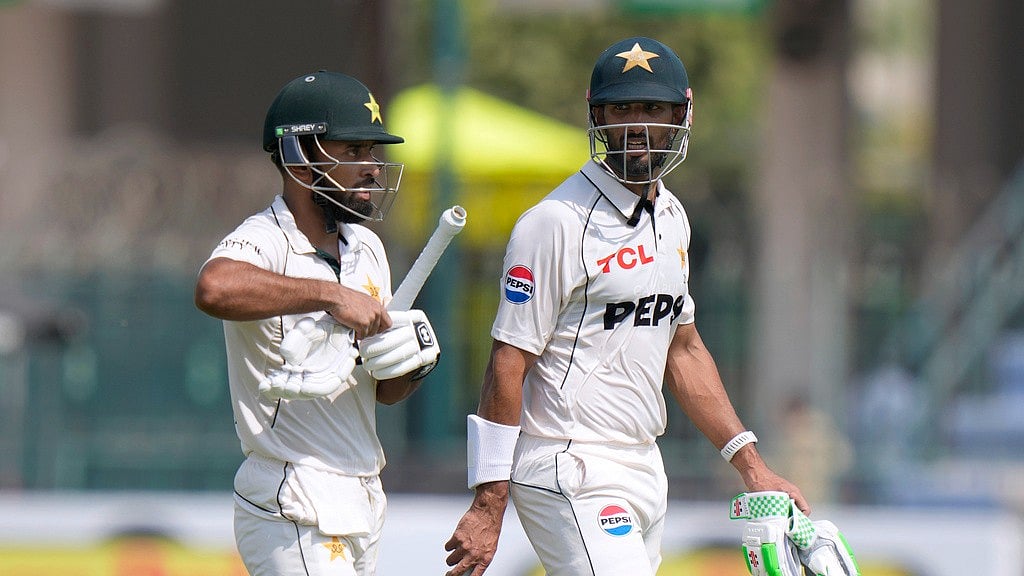 AP/Anjum Naveed : Pakistan's Abdullah Shafique, left, and Shan Masood walk off the field on the lunch break during the first day of the first test cricket match between Pakistan and England, in Multan, Pakistan, Monday, Oct. 7, 2024. 