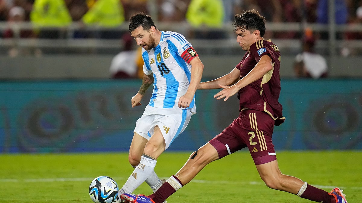 Argentinas Lionel Messi takes a shot challenged by Venezuela. AP Photo