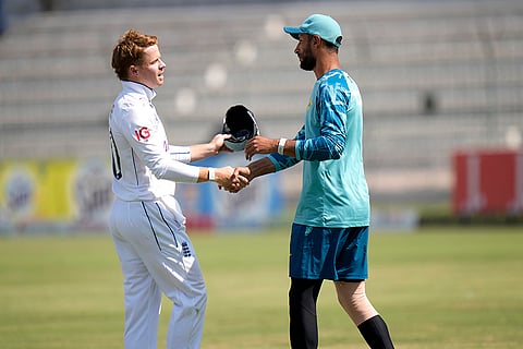 Pakistan vs England 1st Test: England's Ollie Pope, left, shakes hand with Pakistan's Shan Masood