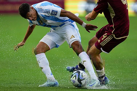 FIFA World Cup 2026 Qualifiers: Argentina's Nahuel Molina, left, battle for the ball with Venezuela's Jon Aramburu
