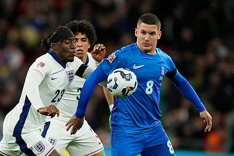 Nations League Soccer: Greece's Christos Tzolis, rihgt, challenges for the ball with England's Noni Madueke, left, and Rico Lewis