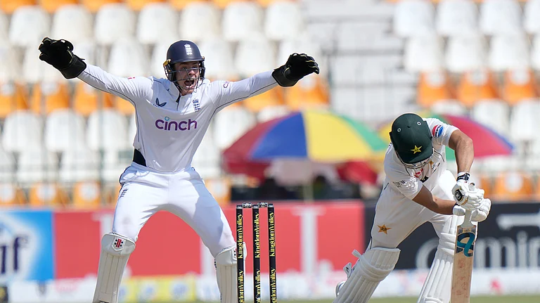 England's Jamie Smith, left, jubilates on the dismissal of Pakistan's Salman Ali Agha during the fifth day of the first test cricket match between Pakistan and England, in Multan. - AP Photo/Anjum Naveed
