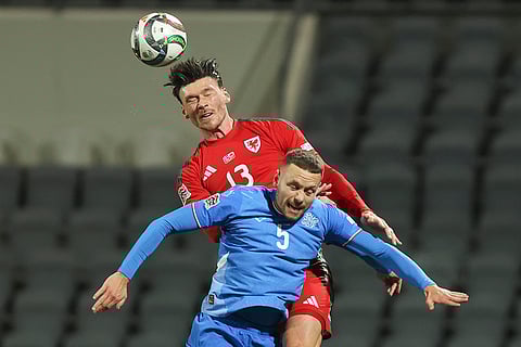 Nations League Soccer: Kieffer Moore of Wales wins a header about Iceland's Sverrir Ingason