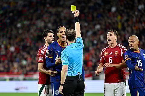Nations League Soccer: Virgil van Dijk, 2nd left, argues with Referee Lukas Faehndrich when he shows him a yellow card