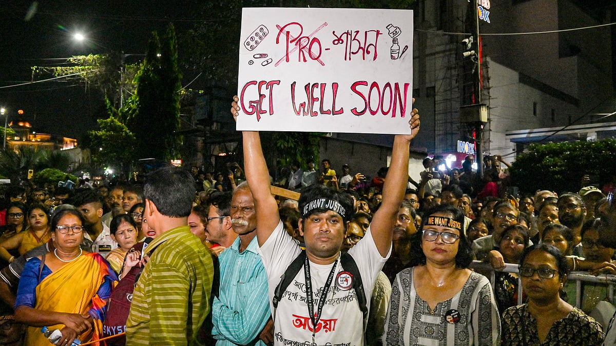 A man holds a placard during a 'mass convention' called by junior doctors near the hunger strike site, protesting against the alleged rape and murder of a trainee doctor, in Kolkata, Friday, Oct. 11, 2024. - PTI