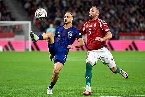 Nations League Soccer: Xavi Simons of the Netherlands controls the ball next to Hungary's Attila Fiola