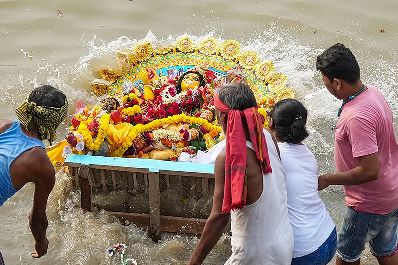 Devotees immerse an idol of Goddess Durga in Kolkata