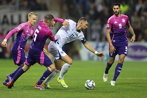 Nations League Soccer: Germany's Pascal Gross holds Bosnia's Edin Dzeko