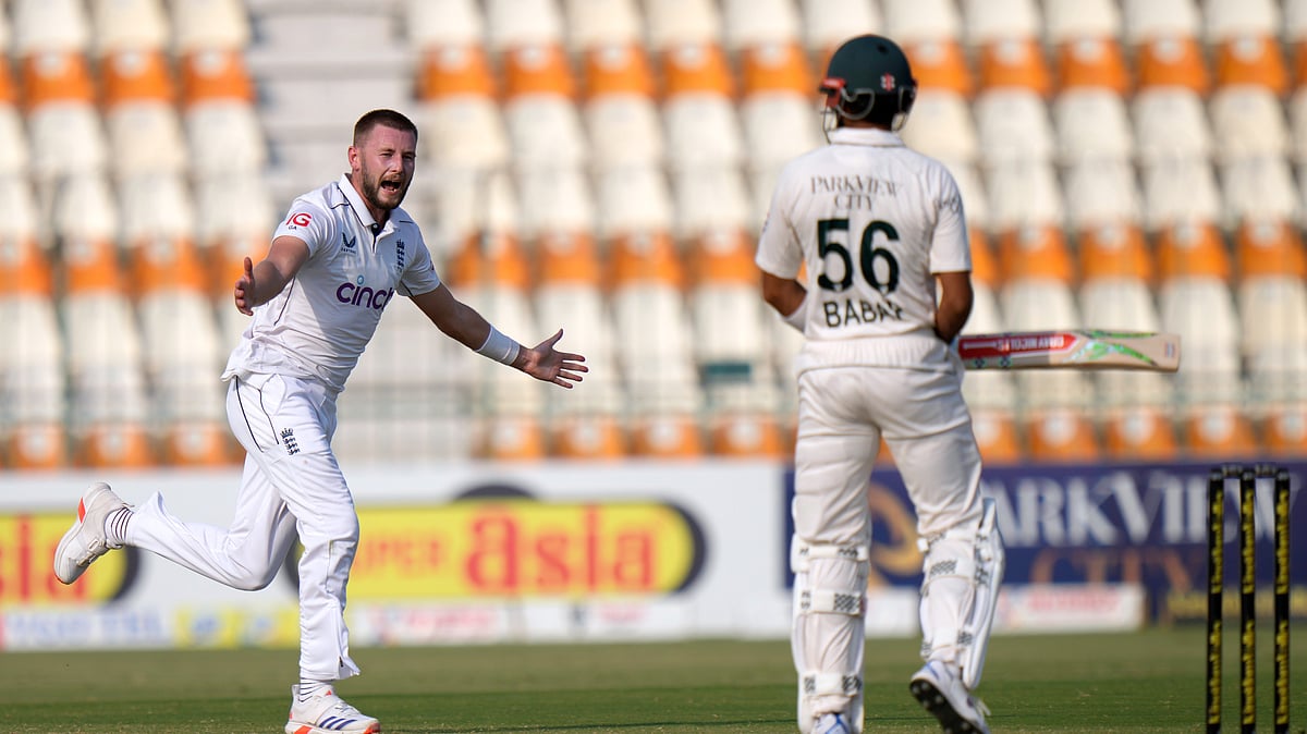 AP Photo/Anjum Naveed : England's Gus Atkinson, left, celebrates after taking the wicket of Pakistan's Babar Azam, right, during the fourth day of the first test cricket match between Pakistan and England, in Multan.