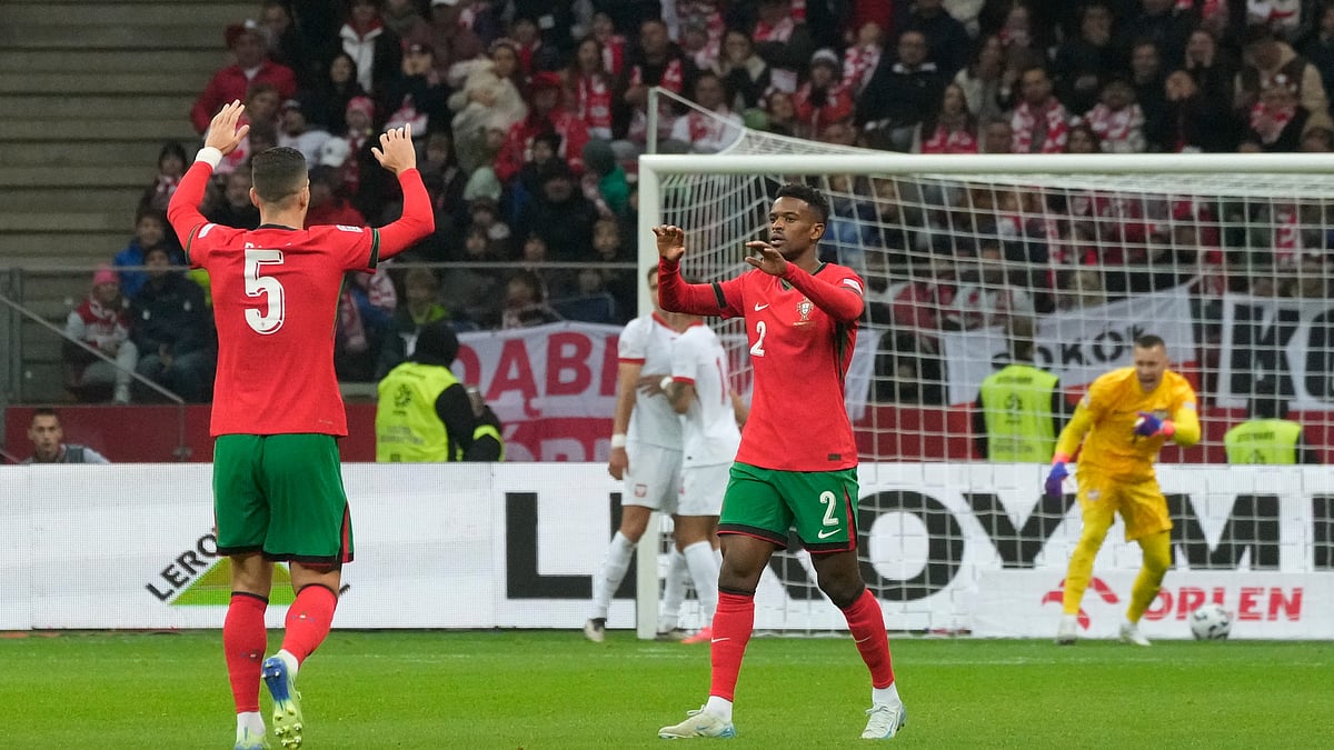 Portugal's Diogo Dalot, left, and Nelson Semedo celebrate after Poland's Jan Bednarek scored own goal during the UEFA Nations League soccer match between Poland and Portugal at Narodowy stadium in Warsaw. - AP Photo/Czarek Sokolowski
