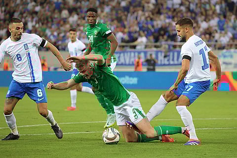 Nations League Soccer: Greece's Pantelis Hatzidiakos, right, vies for the ball with Ireland's Evan Ferguson