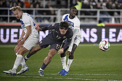 Nations League Soccer: Jack Grealish of England, centre, challenges for the ball with Joel Pohjanpalo, left, and Glen Kamara of Finland