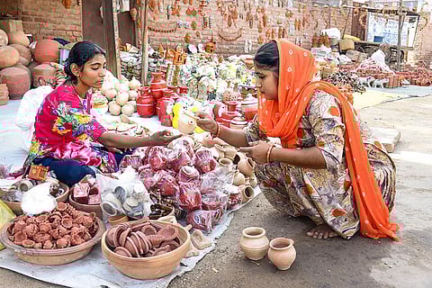 Vendor sells earthen lamps