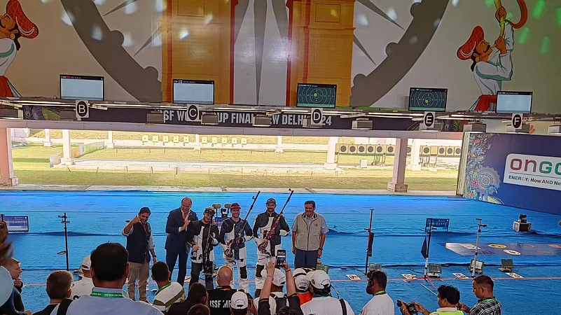 Indias shooter Akhil Sheoran (R) with officials and competitors. Jagdish