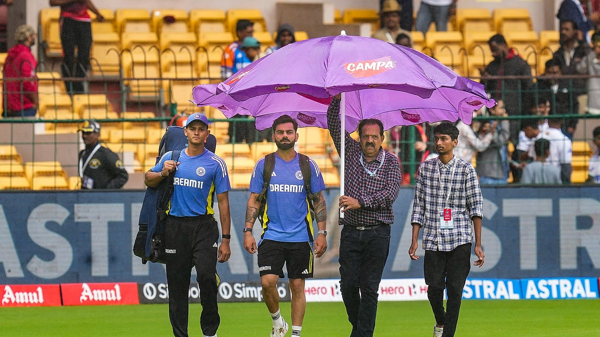 PTI Photo/Shailendra Bhojak : India's Virat Kohli and Yashasvi Jaiswal walk on the field during rains on the first day of the first test cricket match between India and New Zealand at M Chinnaswamy Stadium, in Bengaluru.