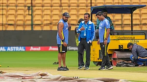PTI Photo/Shailendra Bhojak : India's captain Rohit Sharma inspects the pitch after rain stopped play during the first day of the first test cricket match between India and New Zealand, at M Chinnaswamy Stadium in Bengaluru.