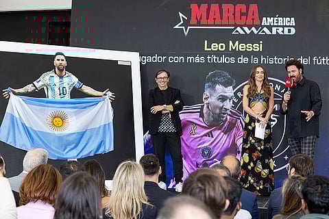 MARCA America Award: Artist Javier Tortosa, far-right, presents Lionel Messi with an art piece