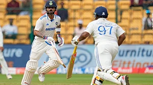 Photo: AP : IND vs NZ, 1st Test: Virat Kohli (left) and Sarfaraz Khan in action against New Zealand on Day 3 in Bengaluru.
