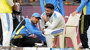 AP Photo/Aijaz Rahi : India's Rishabh Pant reacts in pain as he is attended by a member of support staff after getting hurt during day two of the first cricket test match between India and New Zealand at the M.Chinnaswamy Stadium, in Bengaluru.
