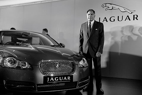Taking Over: Ratan Tata poses with Jaguar for a photograph after a news conference in Mumbai, 2009