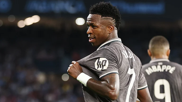 Vinicius Junior laps up his celebration on Saturday after his winner for Real Madrid - null