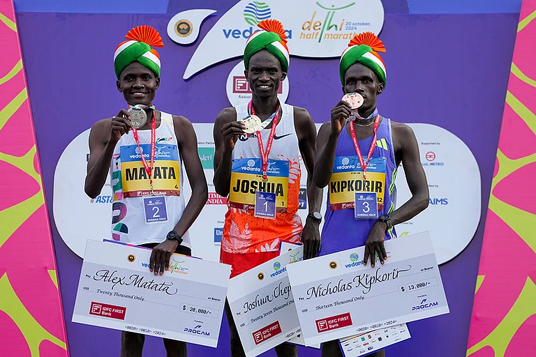 Uganda's Joshua Cheptegei, Kenya's Alex Matata and Nicholas Kipkorir pose with their medals - | Photo: PTI/Atul Yadav