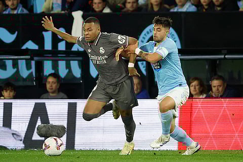 La liga 2024-25: Real Madrid's Kylian Mbappe, left is held by Celta's Fran Beltran