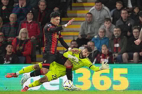 EPL 2024-25: Bournemouth's Evanilson, left, challenges for the ball with Arsenal's goalkeeper David Raya