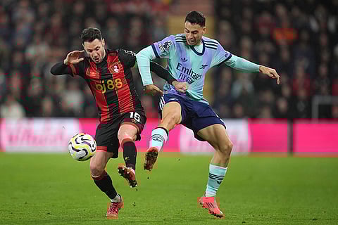 EPL 2024-25: Bournemouth's Adam Smith, left, challenges for the ball with Arsenal's Gabriel Martinelli
