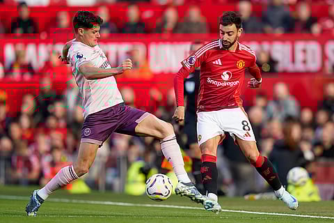 EPL 2024-25: Manchester United's Bruno Fernandes, right, duels for the ball with Brentford's Christian Norgaard