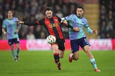 EPL 2024-25: Bournemouth's Adam Smith, left, challenges for the ball with Arsenal's Gabriel Martinelli