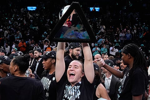 WNBA Finals: New York Liberty guard Sabrina Ionescu holds up the championship trophy